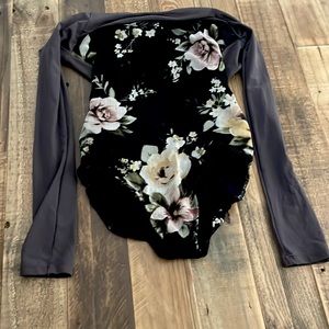 This is a floral Five Dance-wear leotard. Size YXL.